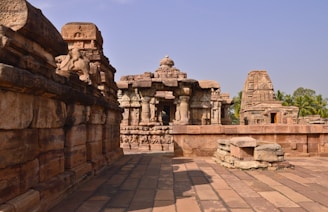 Close-up of intricate stone carvings on the walls of the Bayon temple surrounded by lush green jungle.