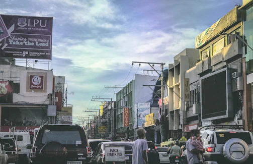 A busy Chennai street with vehicles and commercial buildings under a clear sky.