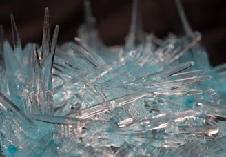 Close-up of a shimmering crystal formation glowing under futuristic blue light.