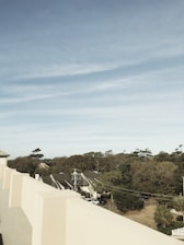 Chris conducting a detailed roof inspection on a suburban home under a bright sky.