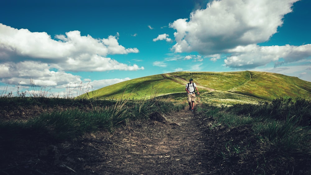 man walking along trail