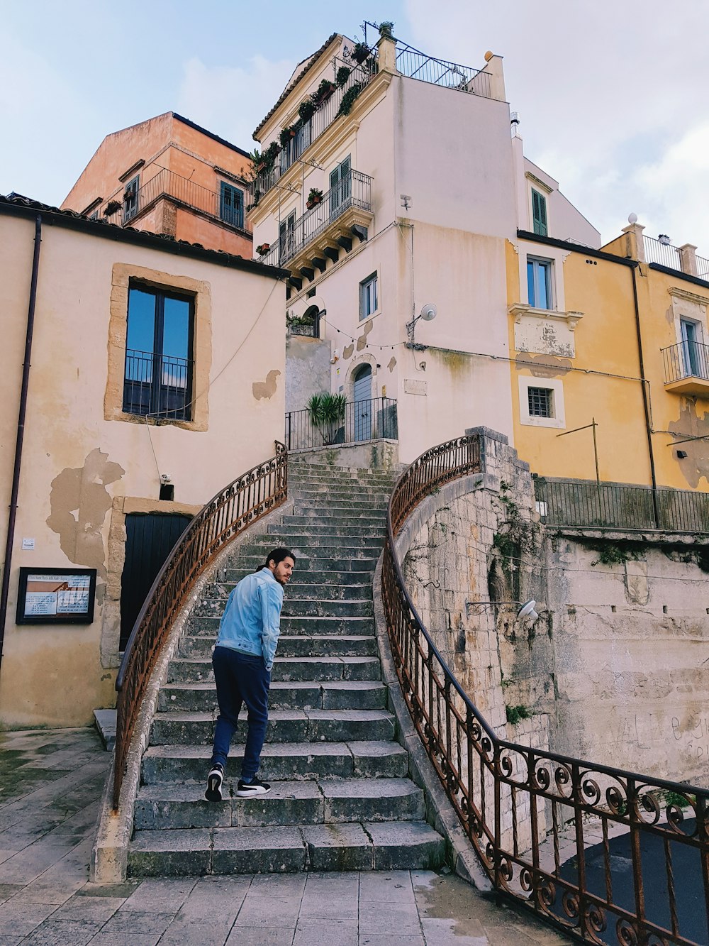 man walking on concrete stairs