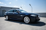 Front view of a sleek used sedan parked on a city street in Salta under clear blue sky
