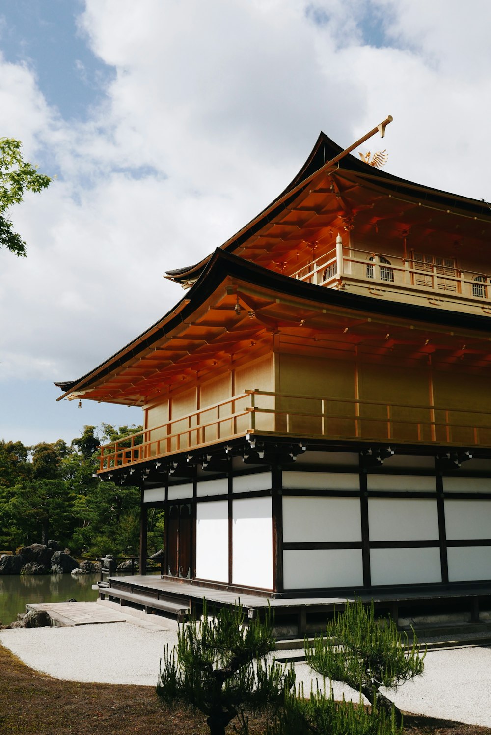 brown and white wooden house under white cloud during daytime