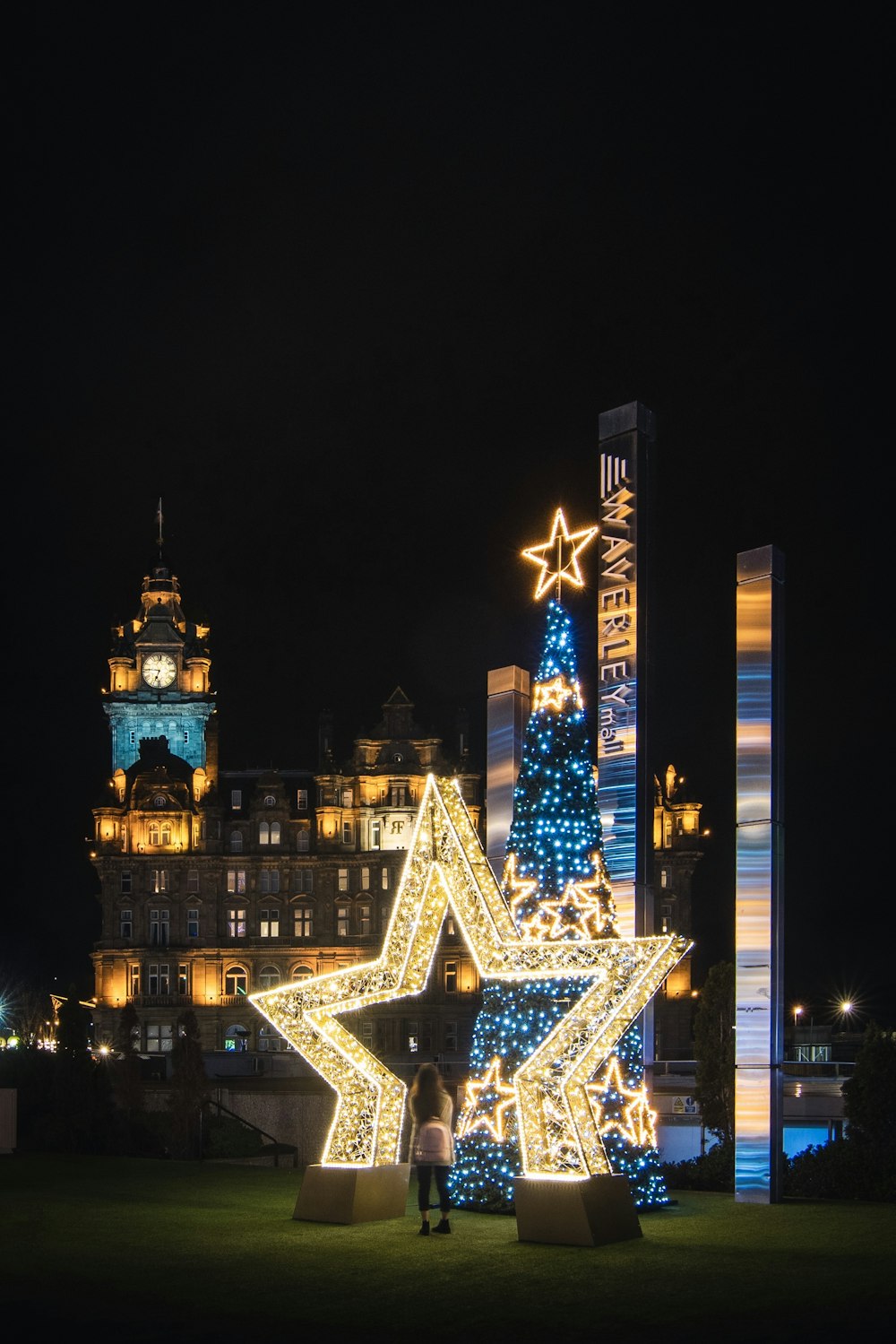 person standing on lighted star arch