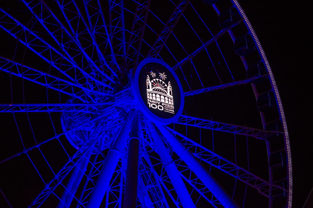 blue Ferris wheel with lights turned-on - The world’s first Ferris wheel was unveiled at the 1893 Chicago World’s Fair, and in 2016, Navy Pier got a new one. The year-round 20-story attraction features 42 enclosed climate-controlled gondolas, perfect for viewing sunsets and the Chicago skyline. The new Ferris wheel had its grand opening in summer 2016, kicking off Navy Pier’s summer centennial celebrations.
