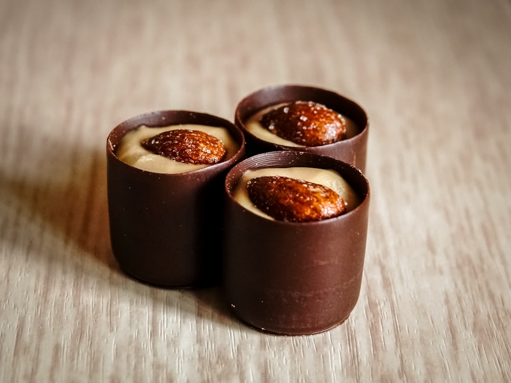 three chocolates with almonds on top