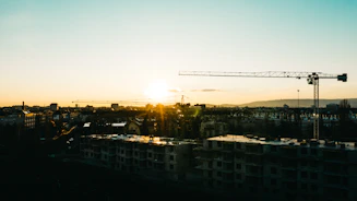 Austin city skyline at sunset with construction cranes in view.