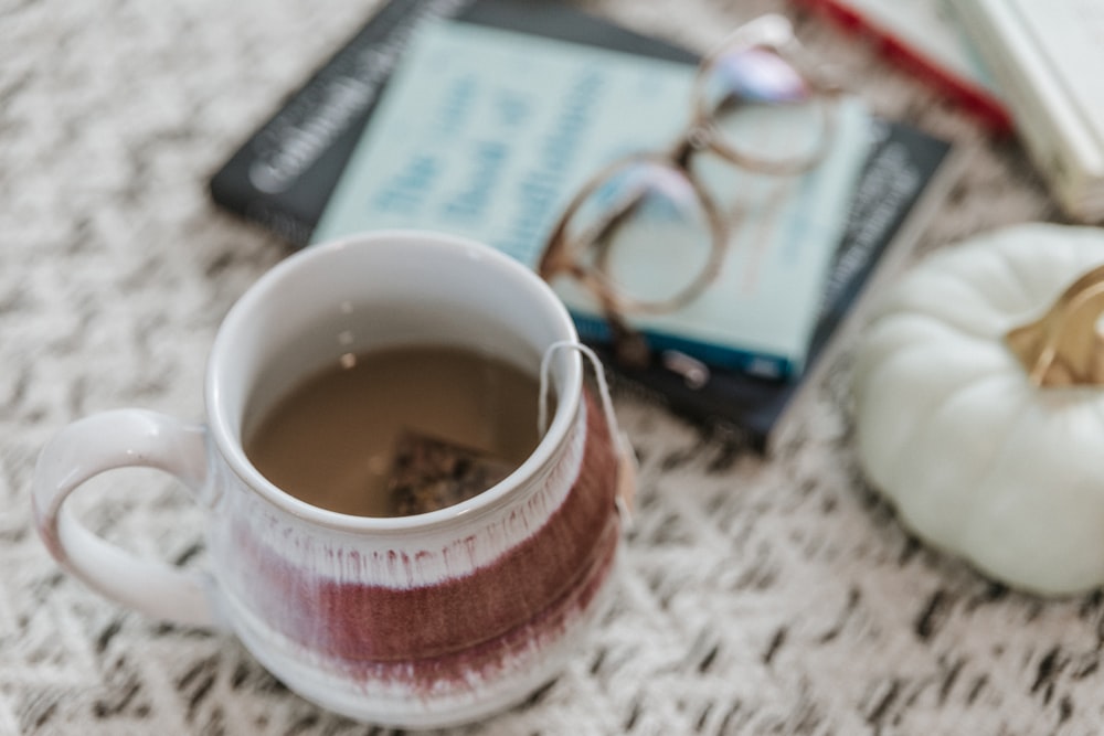 brown liquid filled ceramic mug