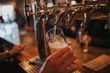 person filling beer on glass