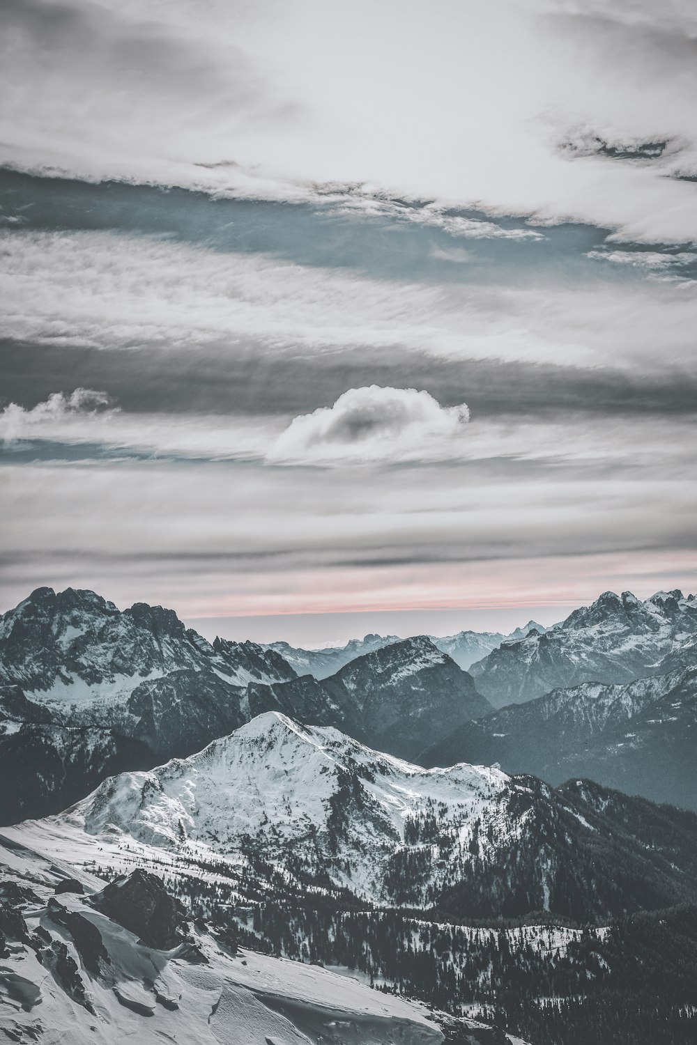 snow capped mountains under white sky