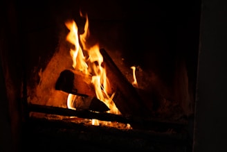 A warm fireplace with a crackling fire, surrounded by a comfortable living room.