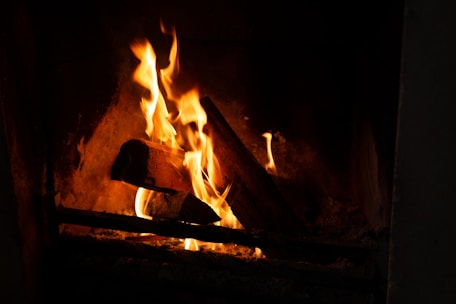 A warm fireplace with a crackling fire, surrounded by a comfortable living room.