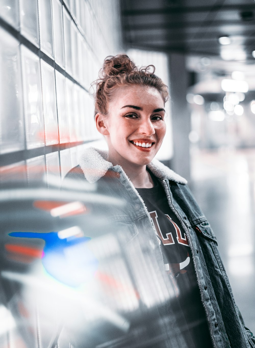 smiling woman wearing blue denim jacket