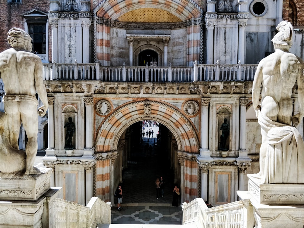 people standing under concrete arch during daytime