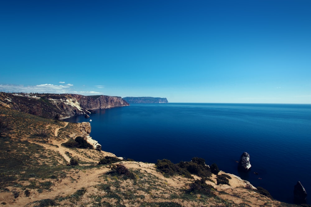 body of water surrounded by rock