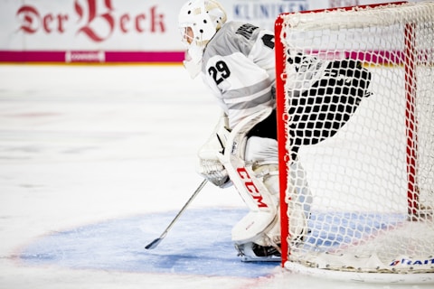 person guarding goalie net in field