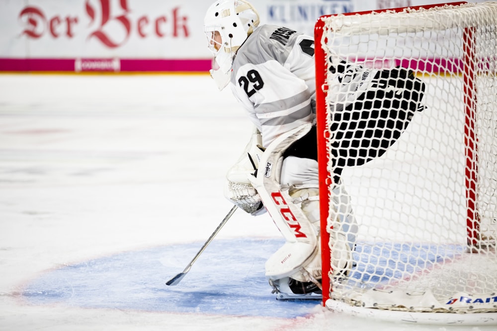 person guarding goalie net in field