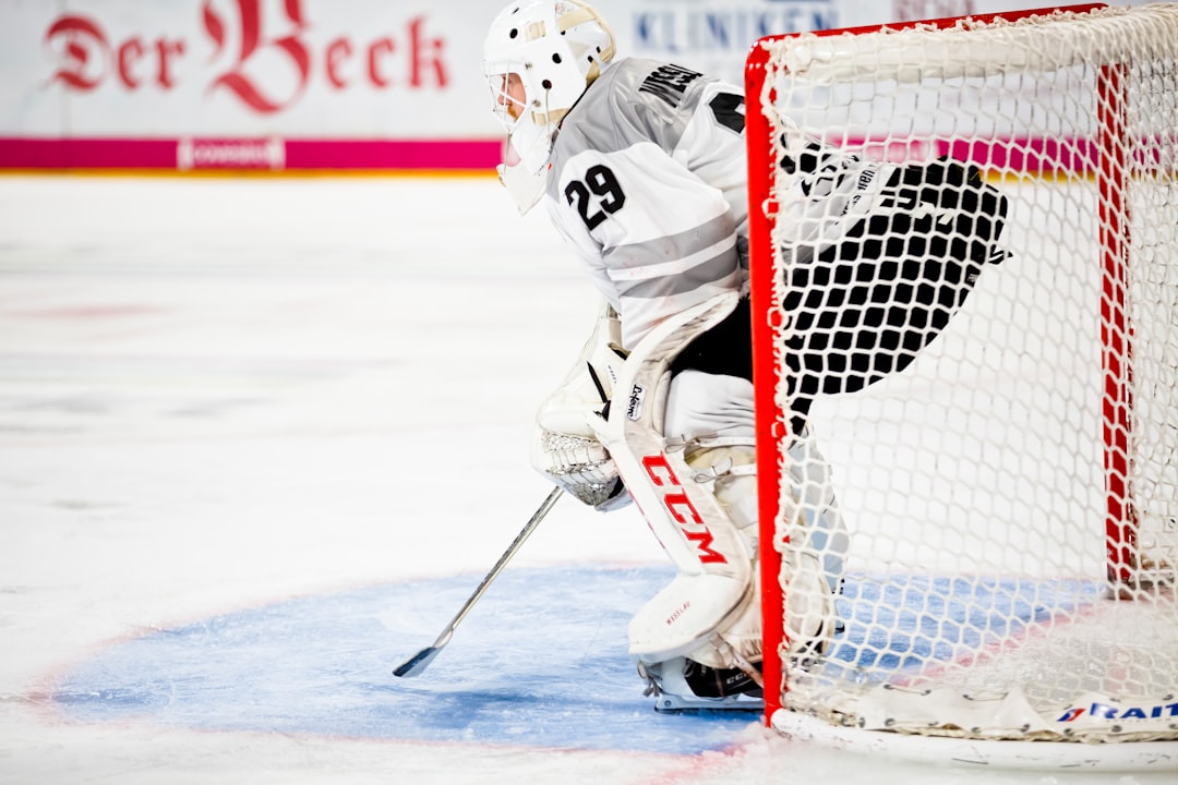 person guarding goalie net in field