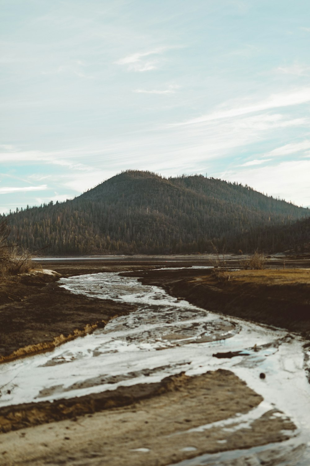 river towards mountain under blue sky