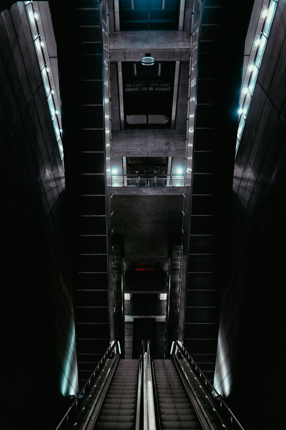 two escalators on dim lighted building