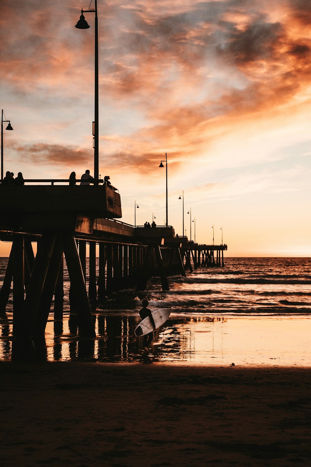 brown wooden boardwalk under cloudy sky during golden hour