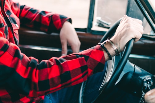 person holding steering wheel