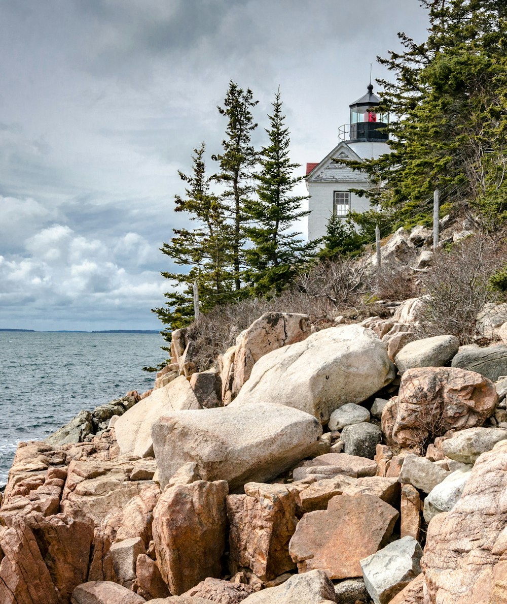 white concrete house near body of water