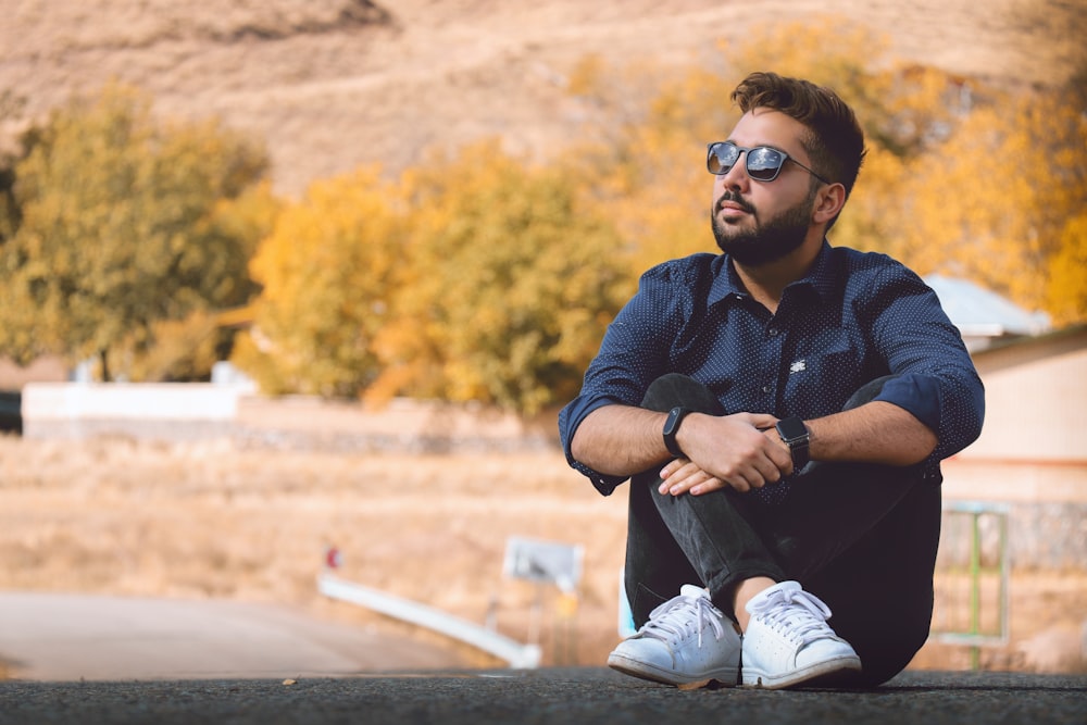 man sitting on black marble surface