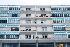 Modern residential building facade with large windows and balconies in Lübeck.