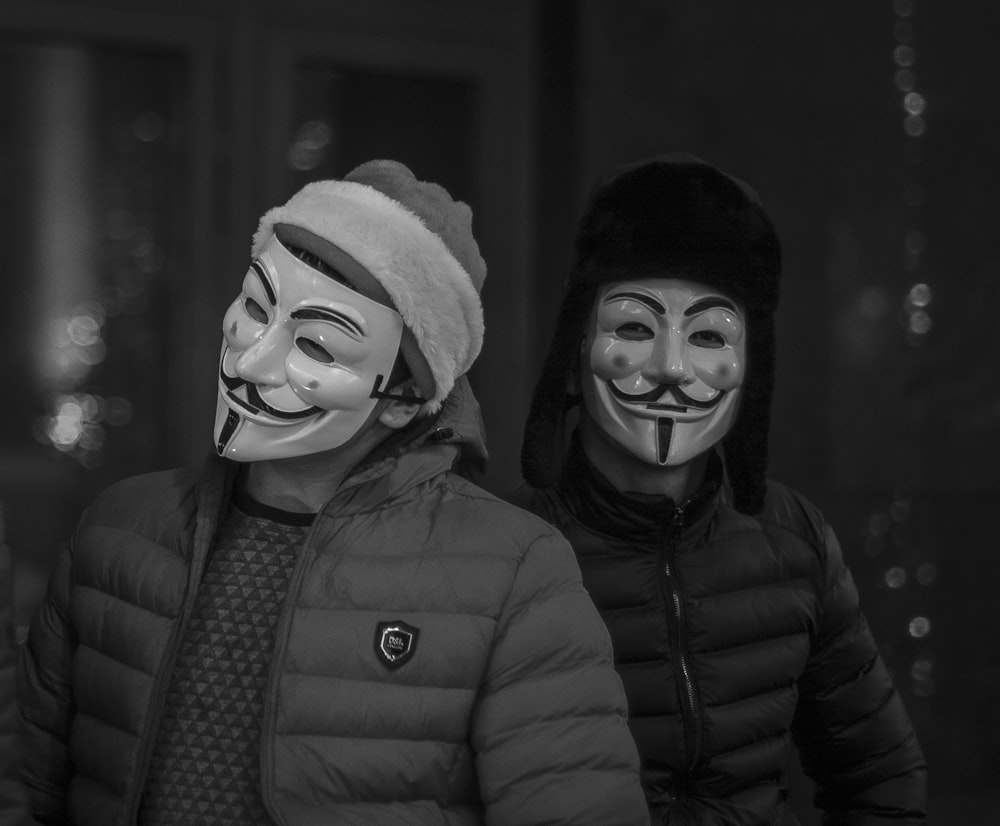 two person wearing Guy's Fawkes Masks