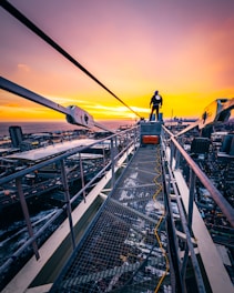 man standing on gray bridge