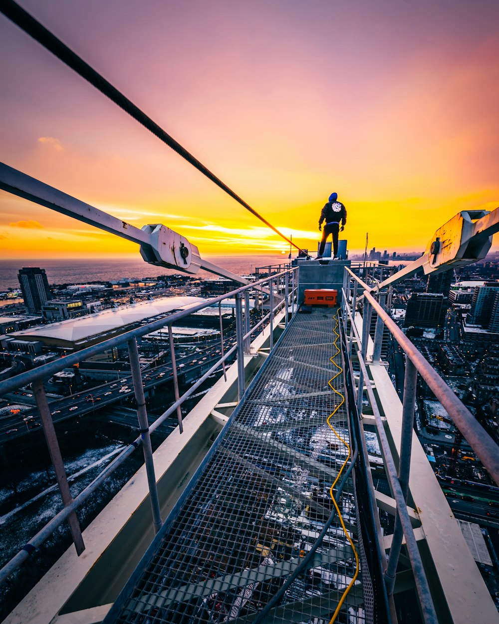 man standing on gray bridge