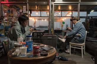 Couple exchanging messages on their phones in a cozy setting.