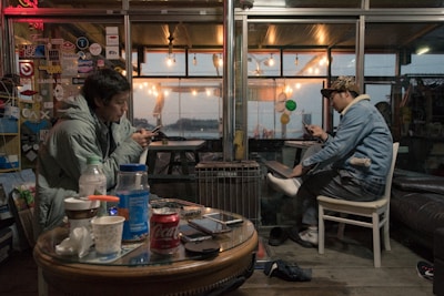 Couple exchanging messages on their phones in a cozy setting.