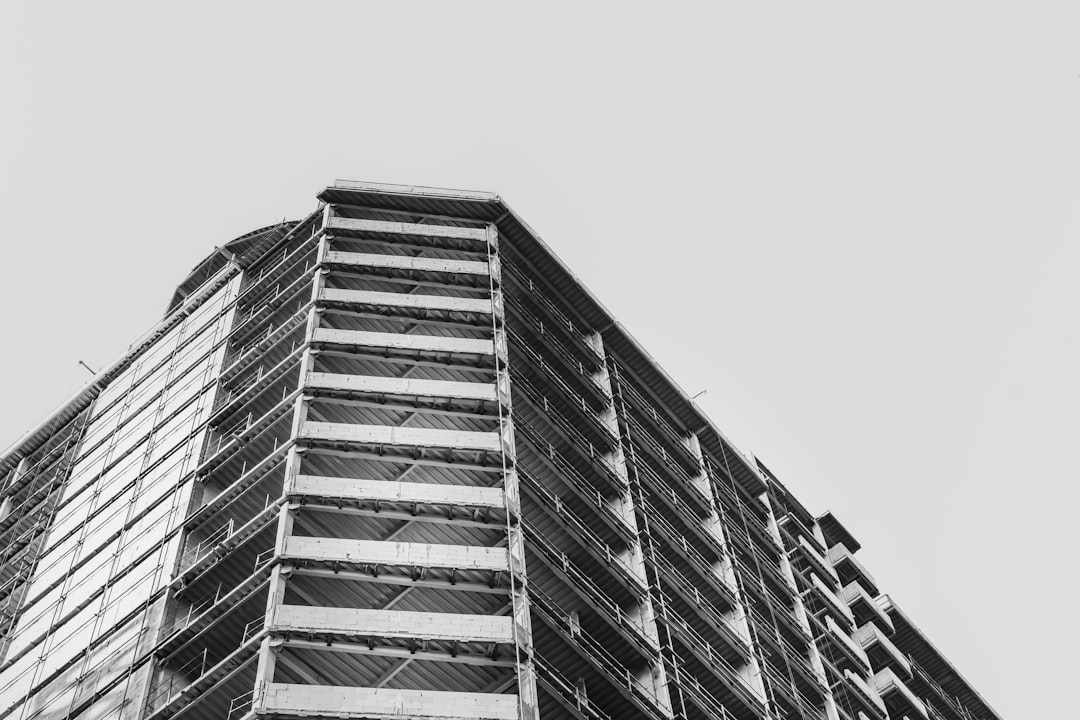 low-angle grayscale photography of concrete building during daytime
