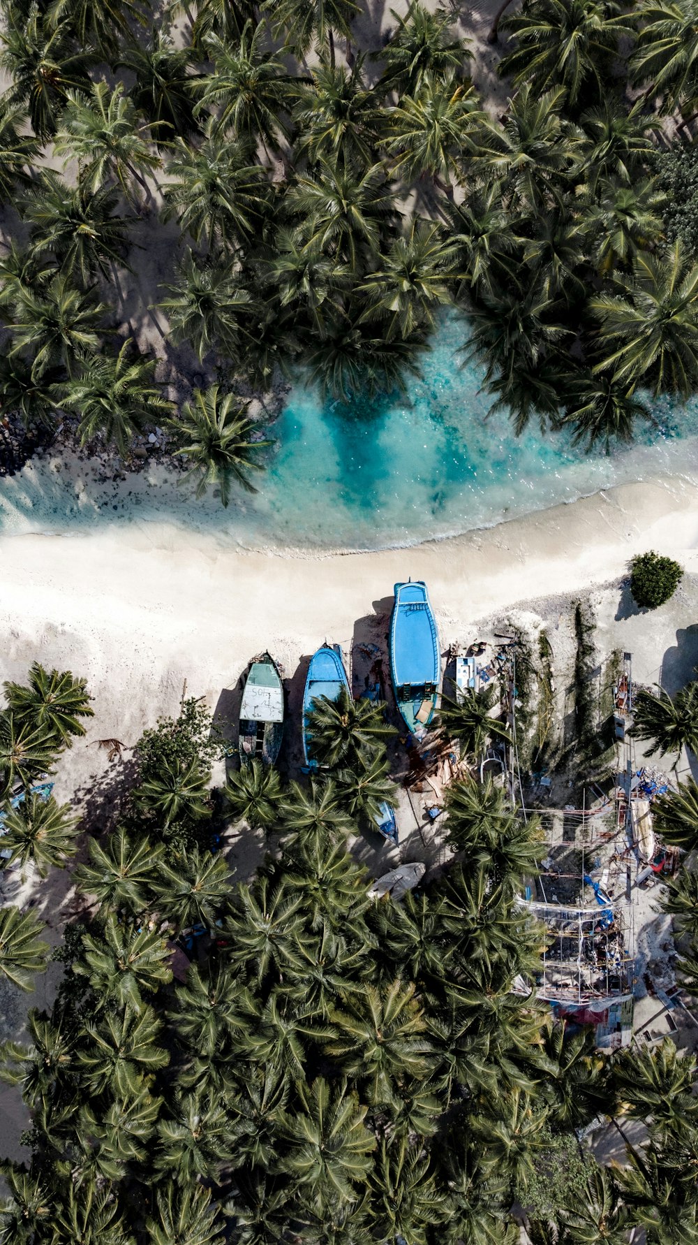 aerial photography of three boats on island