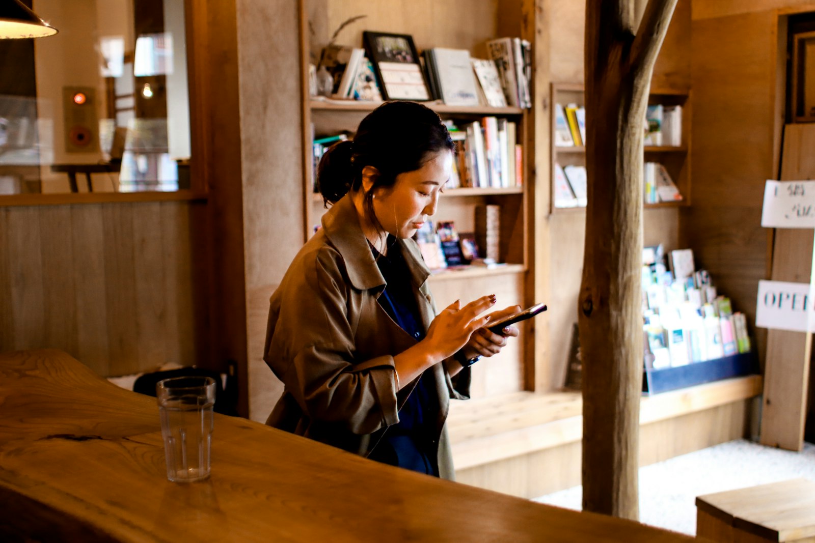 Canon EF 28mm F1.8 USM sample photo. Woman using mobile phone photography