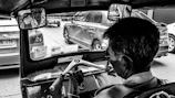 Close-up of a driver checking paperwork inside the polished interior of a cab