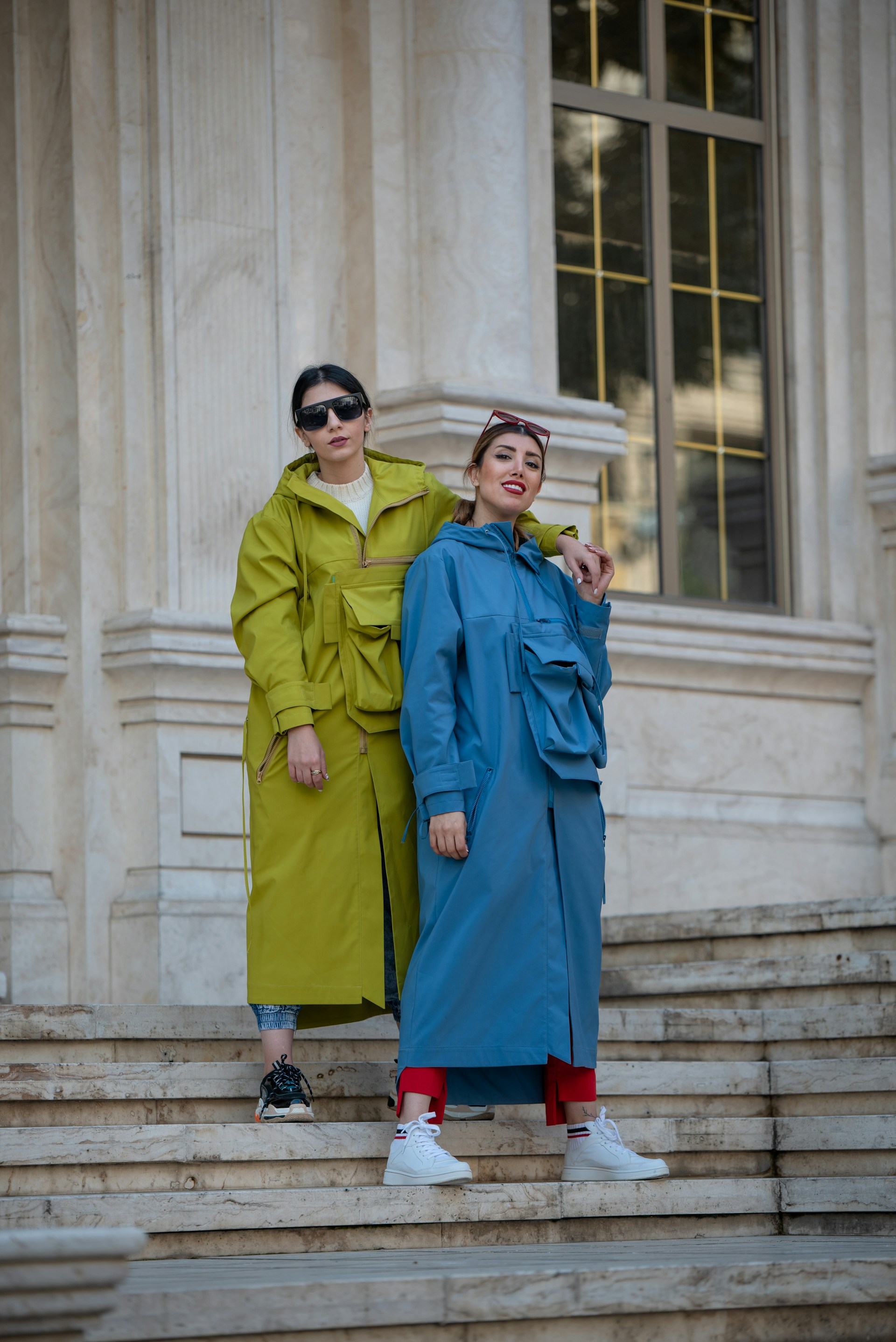 two women wearing coat standing on staies