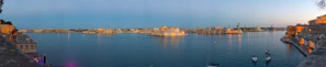 A panoramic view of a historic harbor where cultures and goods once converged.