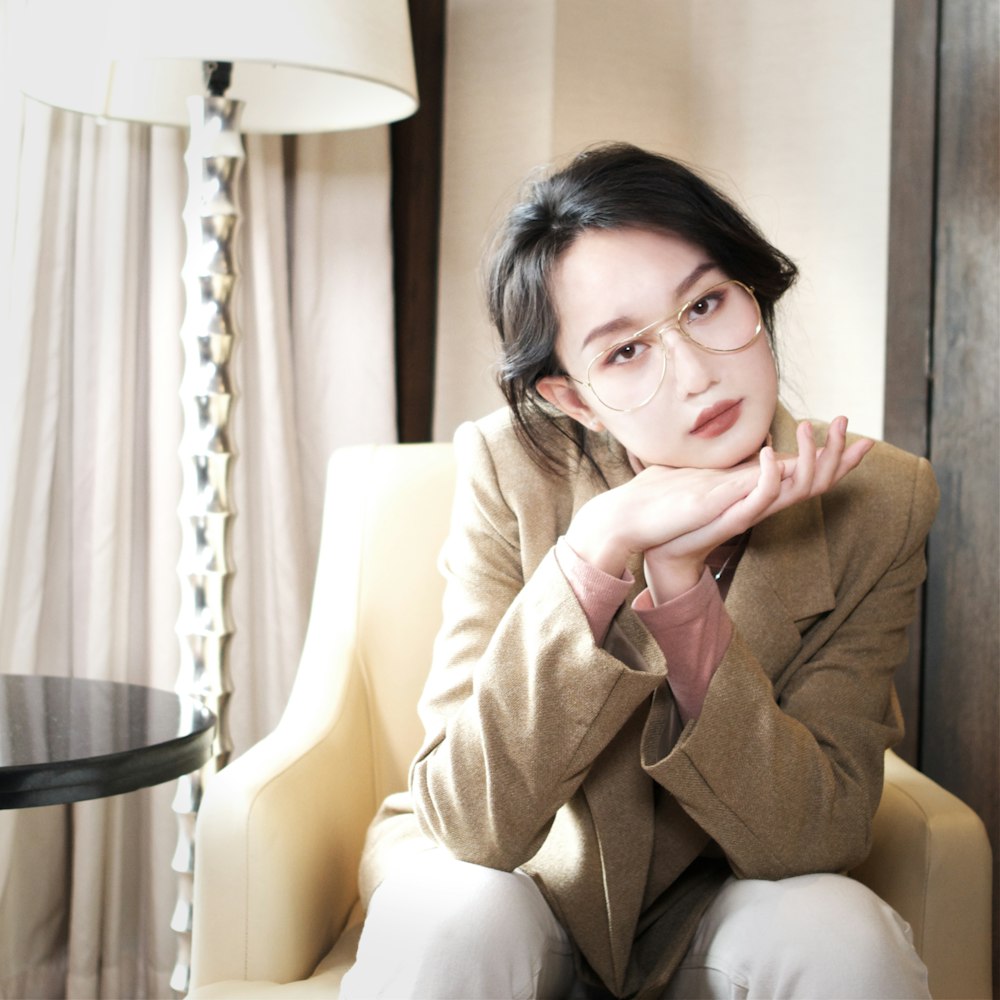 woman sitting on beige armchair indoor