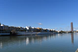 A serene riverside view of the modern iki village high-rise building during daytime