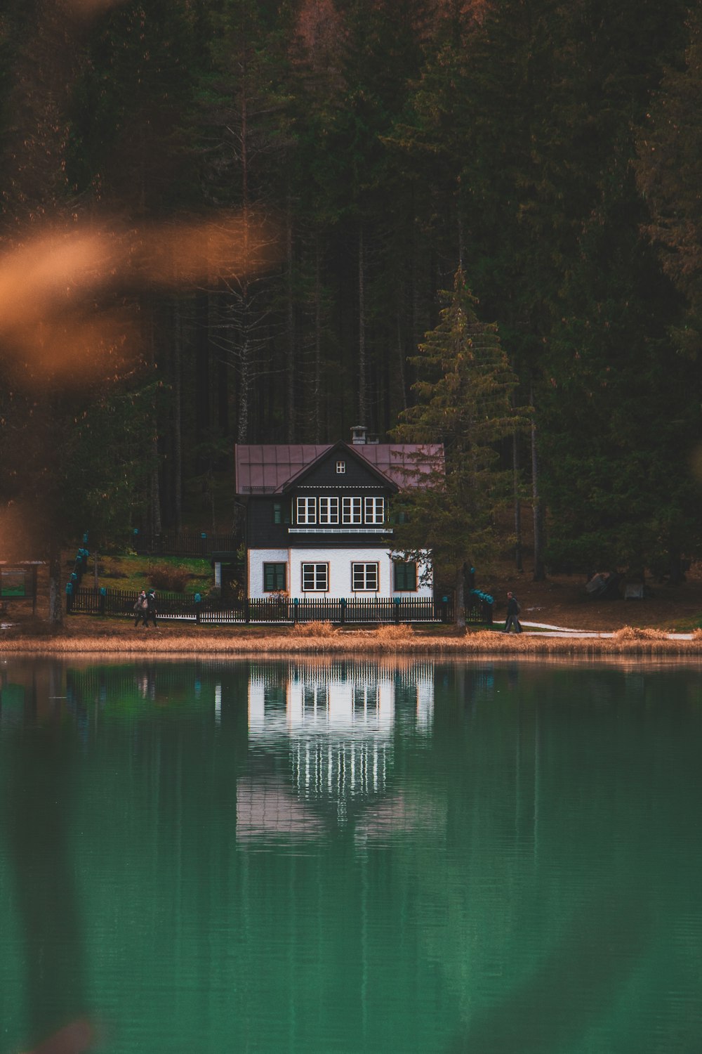 white and black painted house near body of water