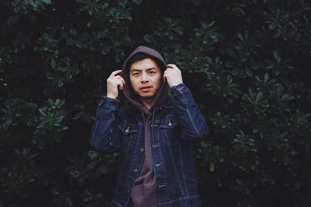 man wearing denim jacket with hoodie