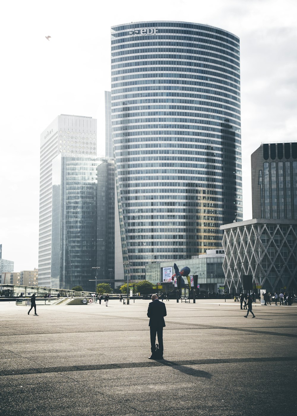 person standing at road near gray concrete building