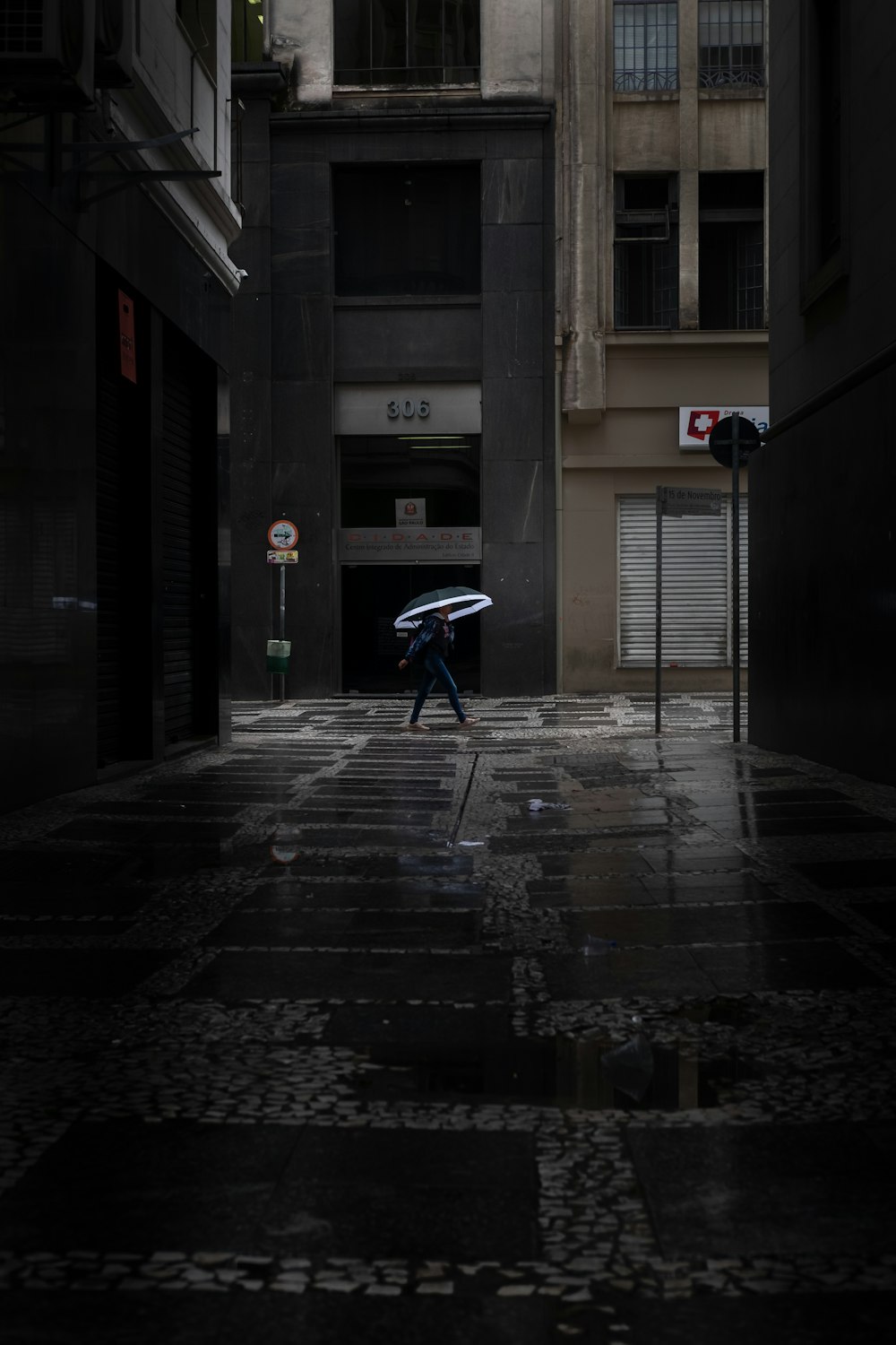 person walking holding umbrella