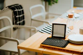 A cozy dining table set with minimalist tableware and colorful coasters.