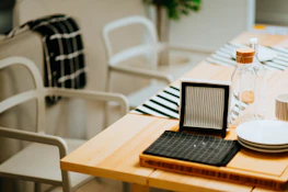 A cozy dining table set with minimalist tableware and colorful coasters.