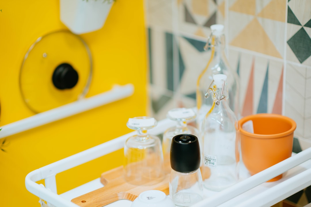 clear glass bottle on white rack